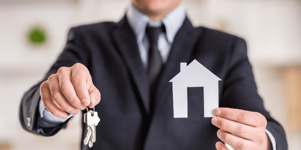 A real estate agent handing over the keys to a Lafayette, LA home.